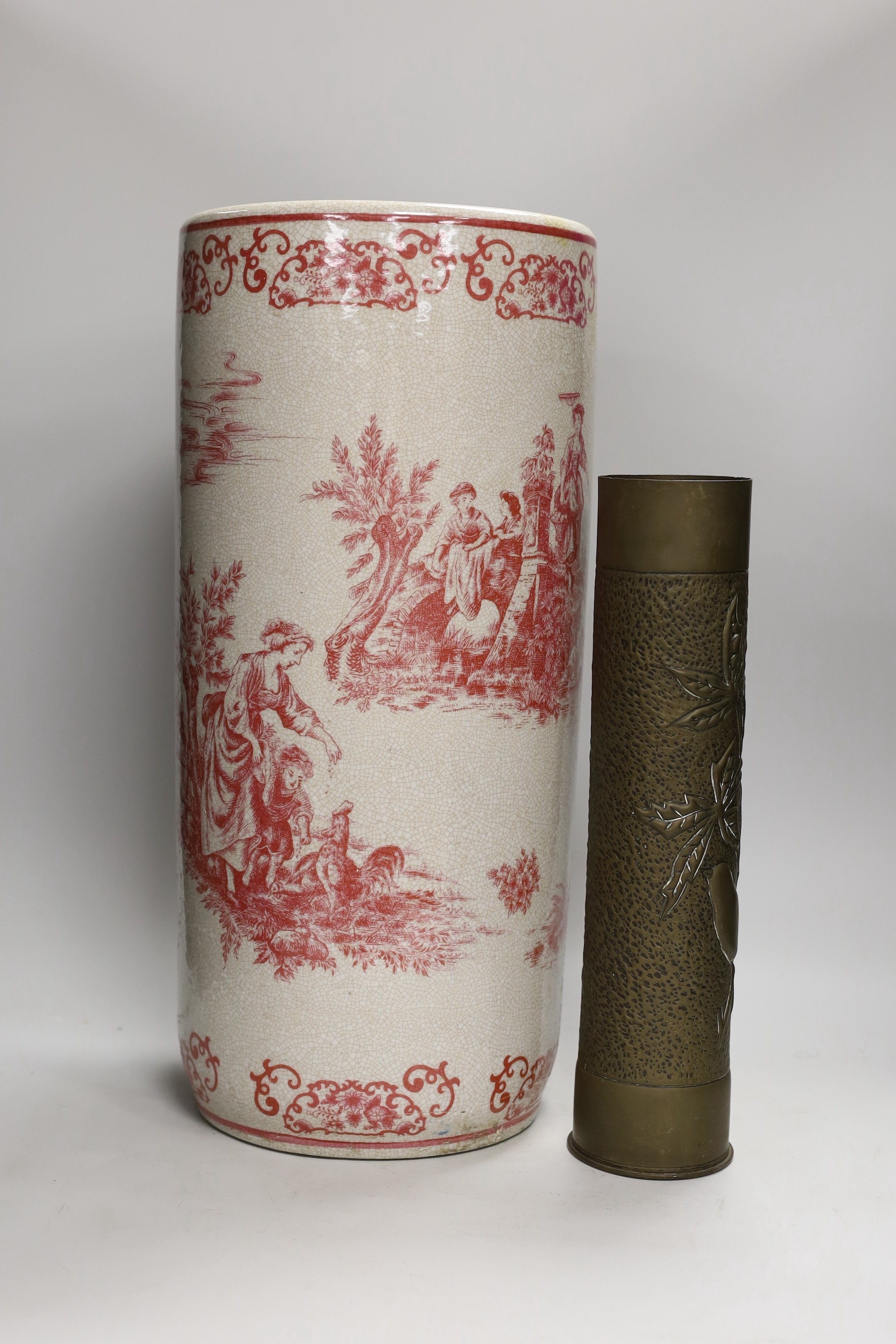 A 20th century crackle ware pottery stick stand, with toile de jouy all over design and a trench art vase, stick stand 48cms high